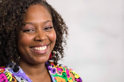 Portrait of Kali Woodruff Carr smiling warmly.