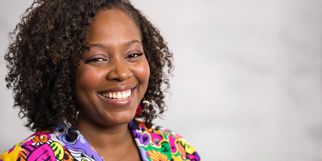Portrait of Kali Woodruff Carr smiling warmly.