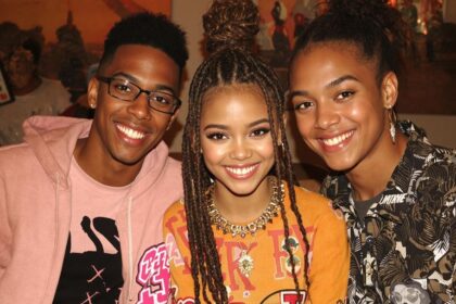 Zendaya smiling with her siblings in a family setting.