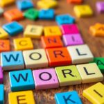 Colorful Wordle game tiles on a wooden table.