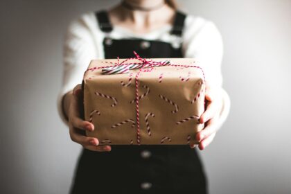 person showing brown gift box; high impact corporate gifting