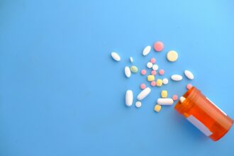 colorful pills spilling from orange bottle; smart packaging